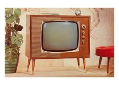 an old tv sitting on top of a wooden stand next to a potted plant