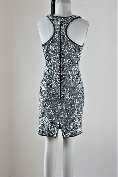 "Fun and Funky, Disco or Party time..this dress has it all... True Trophy ...and with a razor back..oh my!! Excellent condition looks never worn! Measuring: 35\" Length Bust: 34\"+ Waist: 28\" Hip: 36\" Pet Free/smoke free Enjoy!" Silver Sequin Party Dress With Contrast Detail, Silver Sequined Evening Dress For Party Season, Fitted Silver Sequin Fabric For Night Out, Silver Embellished Sequin Fabric For Night Out, Silver Sequin Dress With Contrast For Cocktail, Silver Sequin Dress With Contrast Details For Cocktail, Silver Sequin Dress For Cocktail Occasions, Silver Sequin Cocktail Dress With Contrast Details, Silver Contrast Sequin Fabric For Night Out