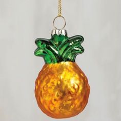 a glass pineapple ornament hanging from a chain