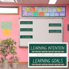 a bulletin board with writing on it in front of a pink wall and two potted plants