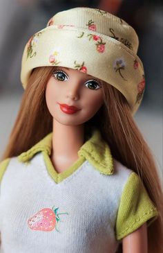 a close up of a doll wearing a hat