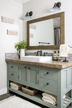 a bathroom with a sink, mirror and rug