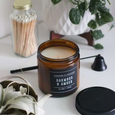 a candle sitting on top of a table next to a potted plant and other items