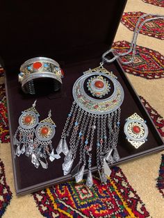 Ethnic Turkmen jewelry set, handcrafted in silver with ornate gold-gilding and vibrant green carnelian  strategically placed highlighting traditional designs. This unique set consists of two hearings, one ring, one bracelet (bilezik) and pendant. The price is for all the items. Turkmen Jewelry, Red Carnelian, Gold Gilding, Vibrant Green, One Ring, Blue Gemstones, Bracelet Necklace, Necklace Silver, Ring Bracelet