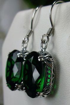 Simulated Green Emerald Earrings Edward Design#E70 Custom Made This is a brand new beautiful Victorian/Edwardian-inspired filigree sterling silver pair of simulated green emerald earrings. The lovely full cut oval stones are 14mm (5/8th of an inch) by 10mm (1/2 inch) in size each. The earrings are marked 925. The earrings are 1 and 1/4th inches long. Notice the beautiful swirl/heart like the craftsmanship of the silver filigree settings. This is a well made beautiful pair of sterling earrings an Nickel-free Green Oval Pendant Jewelry, Green Oval Pendant Jewelry Nickel Free, Green Nickel-free Oval Pendant Jewelry, Green Oval Nickel-free Earrings, Elegant Green Metal Teardrop Earrings, Green Metal Teardrop Earrings Elegant Style, Elegant Green Teardrop Metal Earrings, Green Oval Earrings For Party, Pierced Oval Teardrop Earrings For Gifts