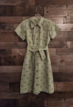 A Lovely Vintage Shirt Dress - 1940's/50's *  Short Cuffed Sleeves  *  Collar  *  Buttons Down Front - Green Moonglow Style Buttons *  Fitted Waist  *  Bust Darts and Waist Darts *  Lightweight Green Cotton Fabric with Mountain Tree Scene Allover print *  Sash Belt or Tie - Matching Fabric - 43"  *  Hand Made Dress  *  Pinking Sheer Seam Ends *  No Labels  *  I noticed a Brownish Spot of Left Hip to I hand washed it.  Spot gone Ready to Wear Actual Measurements:   36"  Bust    27"  Waist   36"  Hips    14"  Shoulders   37"  Length - Shoulder to Hem Remember you need to fit within the measurements given for the best fit, keeping into consideration decade/style and fit of a vintage garment.   Measure a similar item in your closet as reference.    Clothing Items are measured across seam to se Reference Clothing, Green Cotton Dress, Mountain Tree, Tree Scene, Vintage Shirt Dress, Tie Matching, Made Dress, Rockabilly Pin Up, Pin Up Dresses