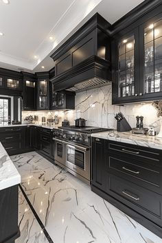 a large kitchen with marble counter tops and black cabinetry, along with stainless steel appliances