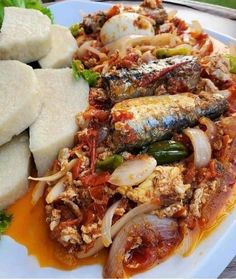 a white plate topped with fish and vegetables