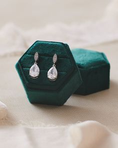 Perfectly sweet, our Callie CZ Earrings are simple dangle earrings designed with a bold CZ stone with ultimate sparkle. Cubic zirconia. Measures 1 inch long. Available in pierced or clip on style. Also available in a Pendant Set or Bridesmaid Pendant Set. Hypoallergenic, lead-free & nickel-free. Style #4209 Pierced; #4296 Clip-on Bride photo credit: Bride - Rey, Photo - Roses & Reeds Photo Clip-on Cubic Zirconia Jewelry Gift, Crystal Drop Clip-on Earrings For Gifts, Classic Crystal Teardrop Earrings For Gift, Classic Cubic Zirconia Clip-on Earrings For Gift, Gift Sparkling Stones Drop Clip-on Earrings, Crystal Clip-on Earrings As A Gift, Nickel Free Drop Clip-on Earrings For Wedding, Nickel-free Drop Clip-on Earrings For Wedding, Anniversary Crystal Clip-on Drop Earrings