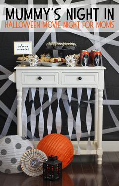 a halloween movie night for moms with an orange ball and black and white wallpaper