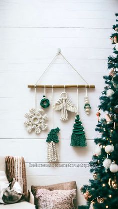 a christmas tree with ornaments hanging from it's sides and a wall mounted ornament