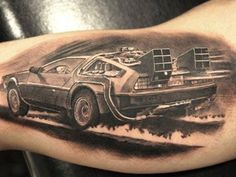 a man's arm with a back tattoo of a delorex car on it