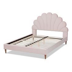 a pink bed frame with an intricate scallop design