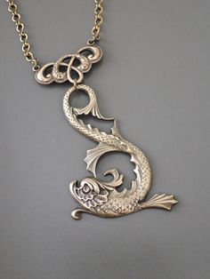 "Vintage Necklace - Art Nouveau Necklace - Dragon Necklace - Chloes Vintage Jewelry - Brass Necklace - handmade jewelry This is an awesome brass stamping of a sea serpent. Remarkable design and detail with a rich patina. It hangs from a vintage brass ladder chain. Chloe says, \"Wear it and feel fabulous!\" The pendant measures 2 1/4 long. You can choose the necklace length you would like at checkout. Thanks for visiting Chloe's" Artistic Bronze Pendant Jewelry, Artistic Engraved Bronze Jewelry, Unique Brass Jewelry With Decorative Details, Decorative Bronze Pendant Jewelry, Bronze Decorative Pendant Jewelry, Artistic Decorative Jewelry As A Gift, Brass Pendant For Crafting, Artistic Decorative Jewelry As Gift, Artistic Decorative Jewelry For Gifts