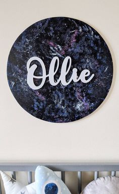 the name ollie is written in white letters on a black and blue marbled background