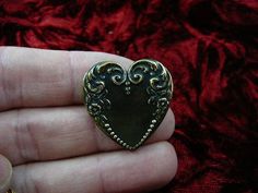 (Internal #B-Heart-13)  This is a heart shaped, piece of reproduction Victorian stamped brass with scrolled flower and dot design, made into a pin/pendant (glued on the back).  This gorgeous reproduction Victorian stamped brass is antiqued, then buffed to create some shine.  This pin/pendant is handcrafted. WE SHIP WORLDWIDE! Other accepted payment: Credit card (Mastercard/Visa/Discover) inquire for details. Antique Heart Brooch For Wedding, Antique Heart-shaped Wedding Brooch, Antique Heart-shaped Brooch For Gift, Antique Heart-shaped Brooches As Gifts, Antique Heart-shaped Brooches For Gifts, Antique Gold Brass Brooch For Gift, Ornate Bronze Brooches For Gifts, Victorian Brooch, Silver Brooch Pin