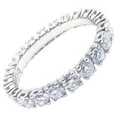 a white gold ring with five rows of diamonds on the inside and outside of it