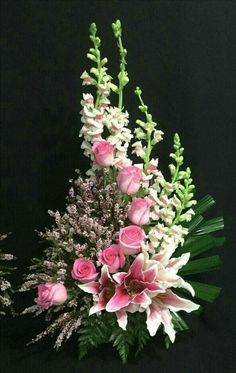 a vase filled with pink and white flowers