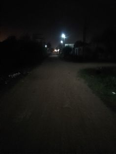 a dark street at night with no cars on it