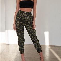 Pants Features: Camouflage Print, Green, Black, Light Green, Brown, High Waisted, Semi-Stretchy, Elastic Leg Hem, Unlined, Front Pockets, Two Big Cargo Pockets, Silver Hardware, Matching Belt.Item Measurements: Length: 38" Waist: 26"Model Is 5’8" And Wearing Size Small (Waist: 23", Bust: 32c, Hips: 34") True To Size Fitted High Waist Camouflage Bottoms, High Waist Fitted Camouflage Bottoms, Stretch Military Camouflage Bottoms, Fitted Camouflage Military Pants, Fitted Camouflage Cargo Trousers, Stretch Camouflage Bottoms With Pockets, Fitted High Waist Camouflage Cargo Pants, Stretch High-waist Camouflage Bottoms, High Waist Stretch Camouflage Bottoms