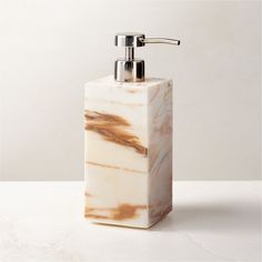 Rectangular soap pump is crafted of Calacatta gold marble with rich natural veining and a smooth finish. Pair with the full Ramsey Calacatta gold marble bath collection for a coordinated look. CB2 exclusive.     Solid Calacatta gold marble  Stainless steel pump  Variation in veining and activity of marble is to be expected; each will be unique  Wipe with a soft cloth  Imported Ramsey Calacatta Gold Marble Soap Pump White Bathroom Storage, Marble Soap, White Bath Mat, Calacatta Gold Marble, Apartment Stuff, Marble Bath, Bath Collection, Large Candle Holders, Calacatta Gold