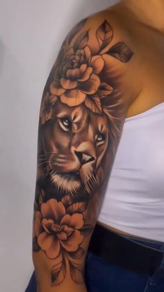 a woman's arm with a lion and flowers on it