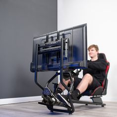 a man sitting in a chair with a computer monitor on it's back legs