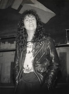 a black and white photo of a woman wearing a leather jacket