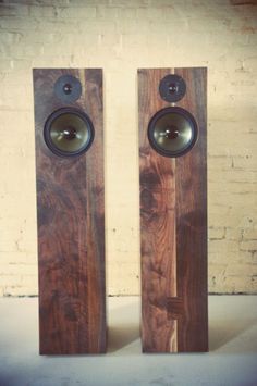 two wooden speakers sitting next to each other