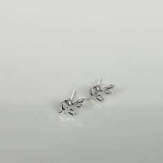 A PAIR of tiny sterling silver leaves on a stem sear studs. Size: 5 x 7 mm These earrings are made of 925 hypoallergenic sterling silver. All my pieces are sent in a gift box. I can include a personal message from you if needed. You are welcome to contact me at... bhavnakwintra1956@gmail.com More hoops: https://www.etsy.com/your/shops/TheSilverGame/tools/listings/section:26305414 More earrings: https://www.etsy.com/your/shops/TheSilverGame/tools/listings/section:26308789 Ear climbers: https://ww Silver Leaf Minimalist Earrings, Silver Leaf-shaped Minimalist Earrings, Minimalist Silver Leaf Earrings, Tiny Sterling Silver Ear Climbers, Minimalist Sterling Silver Leaf-shaped Earrings, Silver Sterling Silver Ear Climbers, Minimalist Leaf-shaped Sterling Silver Earrings, Dainty Silver Hypoallergenic Ear Climbers, Delicate Silver Ear Climbers For Gift