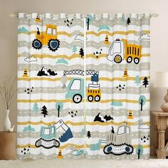 a child's bedroom curtain with construction vehicles on it