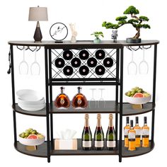 a wine rack with bottles, glasses and plates on it next to a table full of drinks