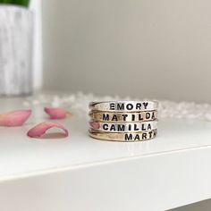 We are so excited to add our Little Id Personalized Stacking Rings to our ring collection. Perfect for stacking just like our original name ring but a little more delicate and feminine. Featuring an upper case letter font, you can comfortably stack up to 5 of these rings. Created to mix and match perfectly with the rest of our collection so you can create a ring stack that's just right for you. Keep your loves close, commemorate a special date or a short meaningful message, use symbols, it's totally up to you. Available options for personalization include heart, star, compass star, infinity symbol. Up to 12 characters max. Our Little ID Personalized Stacking Rings are available in sterling silver, 14kt gold, and rose gold fill. Each ring is hand-formed and stamped in our studio at the time Name Rings, Meaningful Messages, Infinity Symbol, Silver Stacking Rings, Gold Filled Ring, Gold Ring Stack, One Ring, Ring Collections, Gold Filled Jewelry