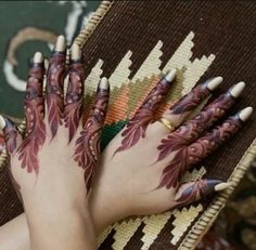 a woman's hands with hennap painted on them