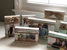 several frames with pictures and bows on them sitting on a table next to a window