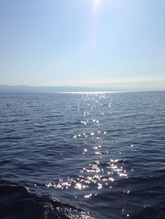 the sun shines brightly on the water as it reflects off the surface of the ocean