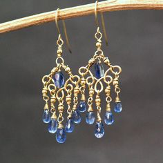 "Blue Kyanite Gemstone Chandelier Earrings Beautiful cobalt blue Kyanite briolettes wrapped with high quality 14k gold filled wire and swings from a gold filled chandelier forms. Dangly, delicate, these are an elegant and feminine, chic statement earrings, perfect for special occasion, wedding, holidays or as a Gift for Her. These are natural, excellent AAA quality gems. Each briolette is faceted beautifully and sparkle with every movement. Mesurements: Kyanite Briolette : 7mm The earrings drop Luxury Fusion Style Gemstone Chandelier Earrings, Sapphire Dangle Jewelry, Blue Wire Wrapped Chandelier Earrings, Blue Brass Dangle Earrings, Blue Wire Wrapped Dangle Chandelier Earrings, Blue Teardrop Wire Wrapped Chandelier Earrings, Blue Long Drop Chandelier Earrings, Blue Teardrop Brass Earrings, Gold Sapphire Dangle Earrings