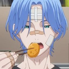 a man with blue hair is eating some food