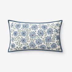 a blue and white pillow with flowers on it