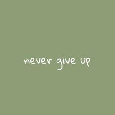 the words never give up written in white on a green background