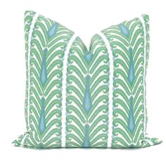 a green and white pillow with blue accents