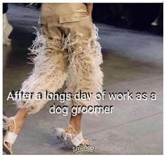 a woman walking down the street with her legs spread out and texting after a long day of work as a dog groomer