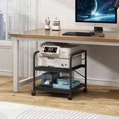 a desk with a computer and printer on it