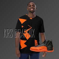 Step up your sneakerhead game with our shirt to match the Jordan 12 Brilliant Orange! 🌟👟 Whether you're a die-hard fan of the iconic Jordan brand or simply love rocking fresh kicks, this shirt is the perfect addition to your sneakerhead wardrobe. With its premium knit mid-weight jersey and jagged graphics inspired by the Jordan 12 Brilliant Orange colorway, you're guaranteed to turn heads and catch eyes. Crafted from a soft, comfortable cotton touch polyester jersey, this shirt is perfect for everyday wear. With its four-way stretch fabric that stretches and recovers on the cross and lengthwise grains, it provides a comfortable and flattering fit for any body type. The regular fit ensures that it's easy to wear and versatile enough to pair with any outfit. The Jordan 12 Brilliant Orange Sports Fan T-shirt, Pre-shrunk, Sports Fan T-shirt With Logo Print For Streetwear, Throwback Sports T-shirt With Relaxed Fit, Throwback Relaxed Fit T-shirt For Sports, Orange Graphic T-shirt For Streetwear, Casual Graphic T-shirt For Sports Events, Orange Graphic Design T-shirt For Streetwear, Graphic Print Athletic Tops For Streetwear, Jordan 12