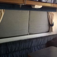 there is a couch and table in the dining car on this train that's parked next to each other