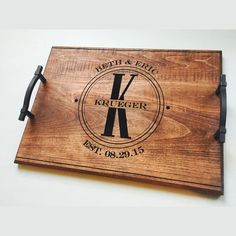 a wooden cutting board with the initials and date on it