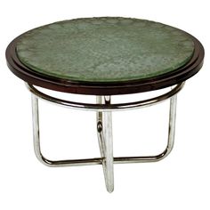 a round glass table with metal frame legs