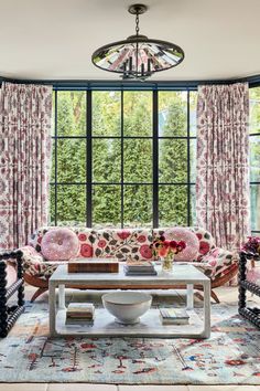 a living room filled with furniture and lots of window treatments on the windowsills