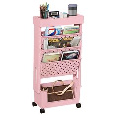 a pink cart with magazines and other items on it's sides, sitting against a white background