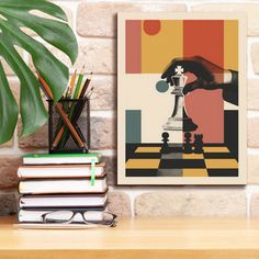 a table with books, glasses and a plant on it next to a wall mounted poster